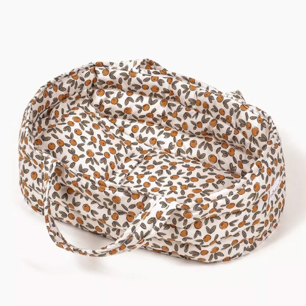 Cotton bassinet and its Orange Blossom pillow